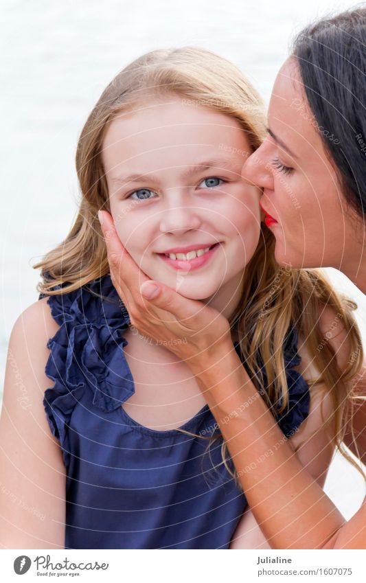 Kissing Caucasian mother and blond daughter Child Schoolchild Girl Woman Adults Parents Mother Infancy 2 Human being 3 - 8 years 8 - 13 years 18 - 30 years