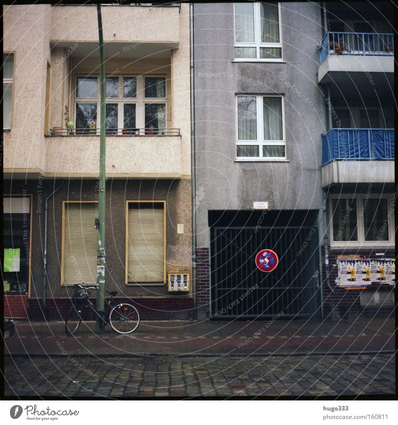 Berlin I House (Residential Structure) Neukölln Signs and labeling Street Winter Housefront Cycle path Cobblestones Balcony Gloomy Window Roller shutter