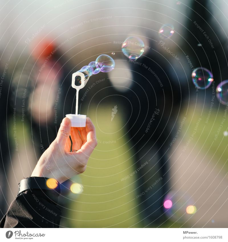 soap bubbles Human being Hand Group Kitsch Small Soap bubble Multicoloured Flying Dream Wind Playing Air bubble Colour photo Subdued colour Exterior shot