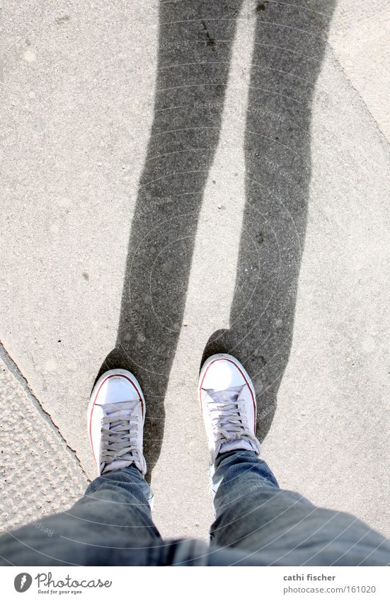 my shoes Feet Legs Jeans Denim Chucks Stand Shadow Floor covering Ground Footwear Pants Street Boredom Wait Sidewalk Beautiful weather White Perspective