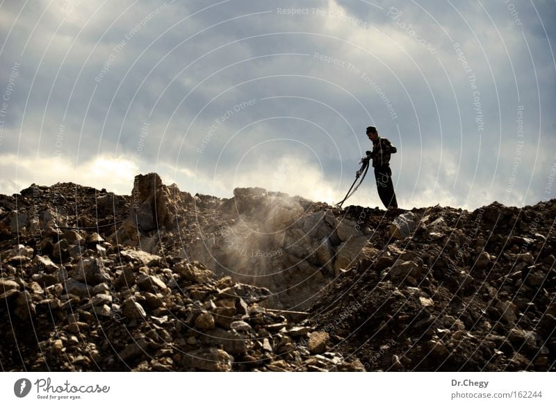 Hard Work Man Works Stone Hill Clouds Dust Sky Digging Grinder Drilling rig Industry Might worker labor driller