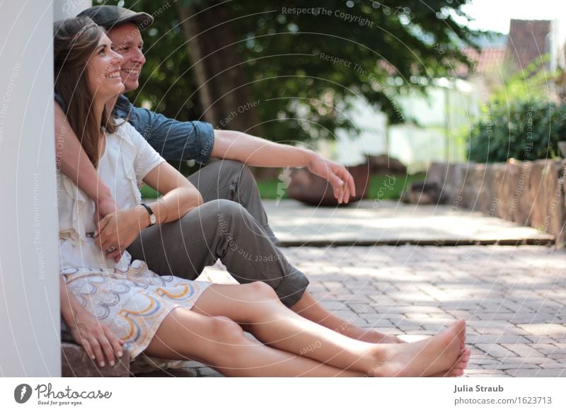 Couple sitting on a small staircase in the courtyard summer Partner Adults 2 Human being 30 - 45 years Summer Tree Bushes Garden Wall (barrier) Wall (building)