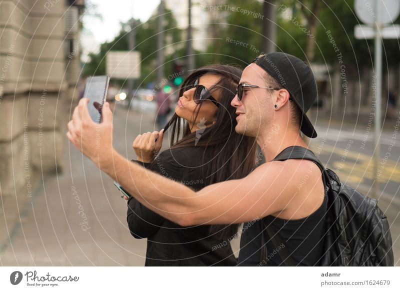 Two cheerful friends taking photos of themselves on smart phone selfie friendship women group people internet street fun happiness smiling lifestyle usrban