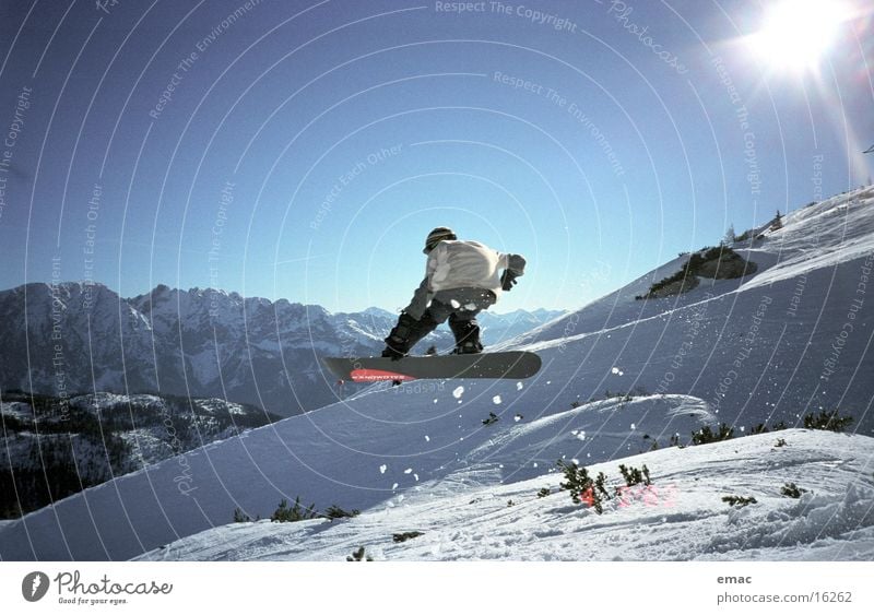 snowboard action 2 Snowboard Jump Action Sports Sun Sunbeam Back-light Flying Posture Mountain range Snowcapped peak Ski run 1 Tall far Blue sky Cloudless sky