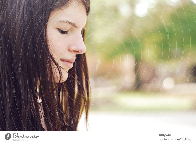 Sunk in thought Colour photo Exterior shot Copy Space right Morning Day Sunlight Shallow depth of field Portrait photograph Downward Looking away Closed eyes