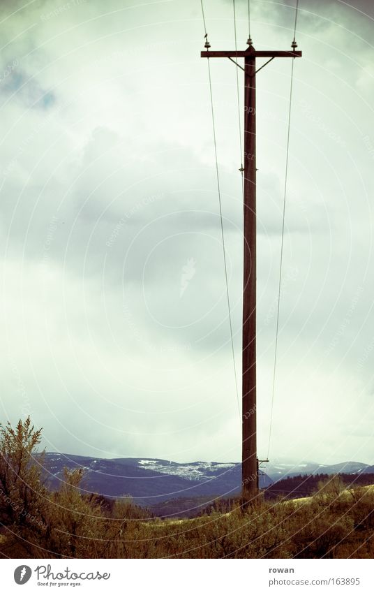 upright Colour photo Subdued colour Copy Space left Day Technology Energy industry Electricity pylon Cable Mountain Thin Strong Vertical Tall Wire