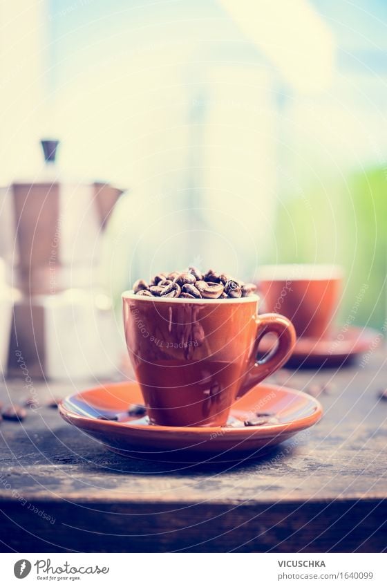 Espresso cup full of coffee beans on the kitchen table Food Beverage Hot drink Coffee Cup Lifestyle Style Living or residing Interior design Table Kitchen