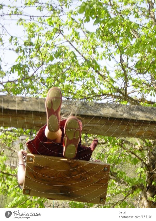 rock Child Human being Legs Footwear Tall Swing Wooden board rocking board Colour photo Multicoloured Exterior shot Worm's-eye view