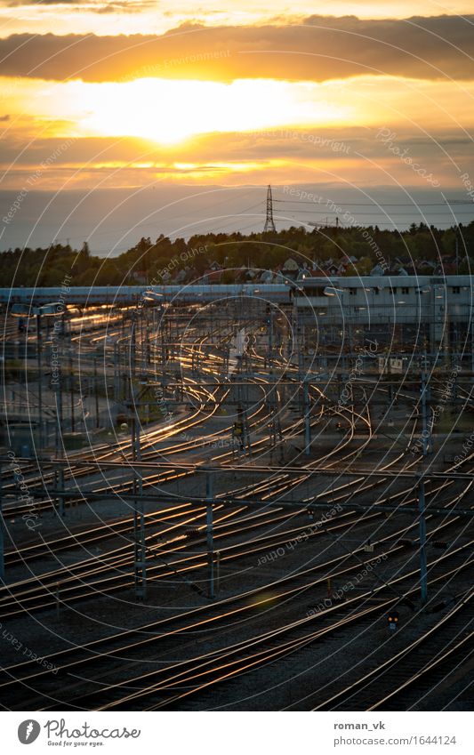 Many roads lead to Stockholm Metal Horizon Railroad tracks Sunset Reflection Orange Clouds Transport Means of transport Rail transport Cold Complex intricately