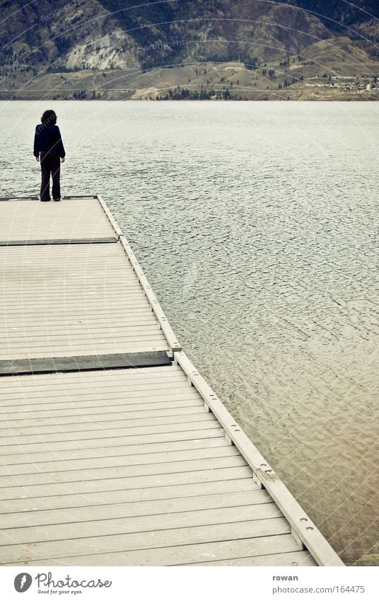 footbridge Colour photo Subdued colour Exterior shot Day Full-length Rear view Human being 1 Water Coast Lakeside Think Stand Gloomy Dream Distress Calm Looking