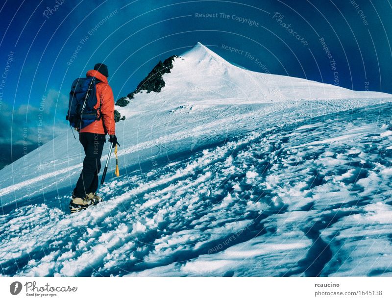 Mountaineer climbs a snowy peak. Climbing Mountaineering Vacation & Travel Hiking Self-confident Success Power Passion Backpacking Brave Climber Determination