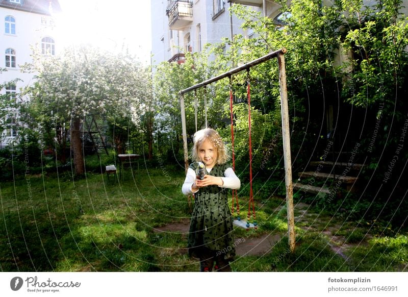 Girl with water gun in the garden Children's game Garden Swing Water pistol Playing Joie de vivre (Vitality) Illuminate Emotions Moody Joy Idyll Infancy Shoot