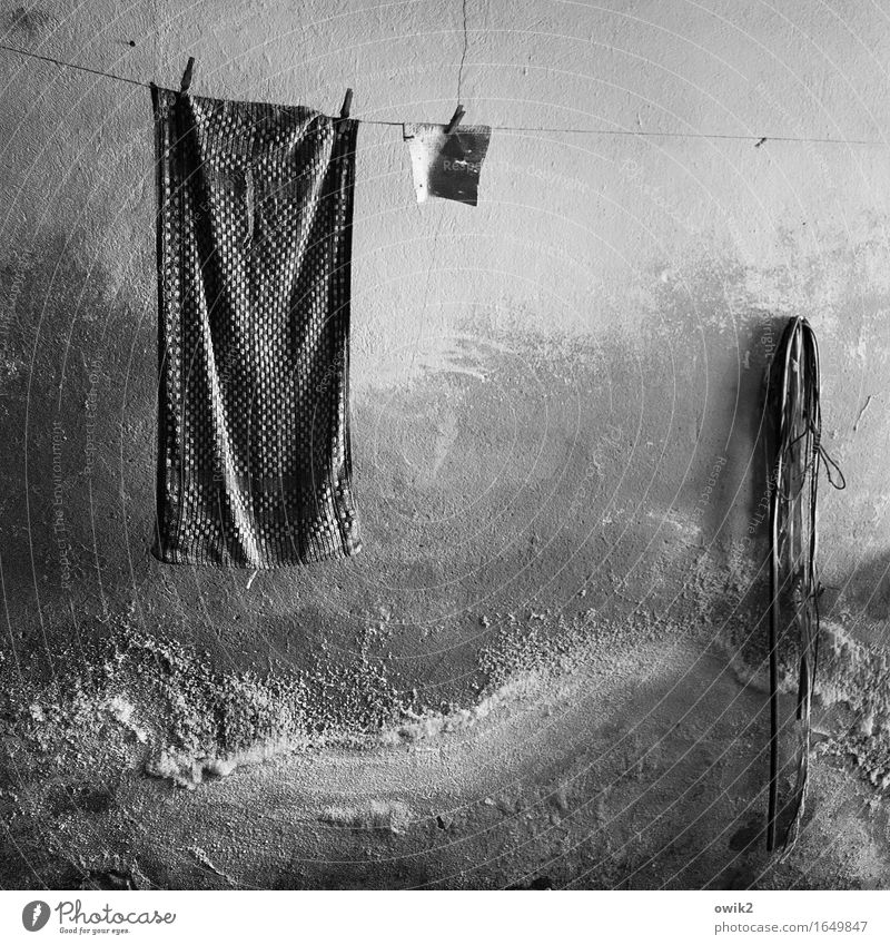 stuck Wall (barrier) Wall (building) Facade Clothesline Towel Rope Clothes peg Hang Old Dark Together Trashy Gloomy Dry Serene Patient Calm Decline Transience