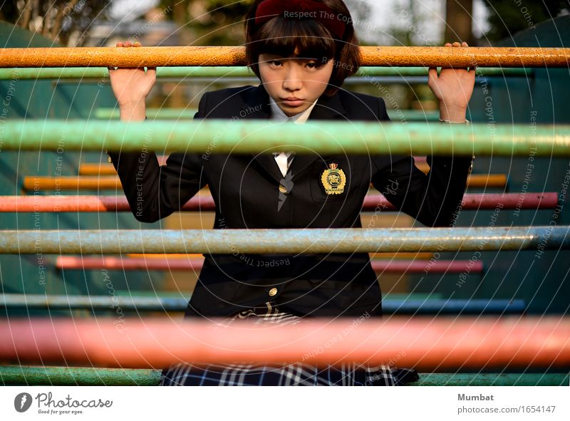 Teen stands amidst colorful poles Study Student Human being Feminine Young woman Youth (Young adults) 1 18 - 30 years Adults Playground Wall (barrier)