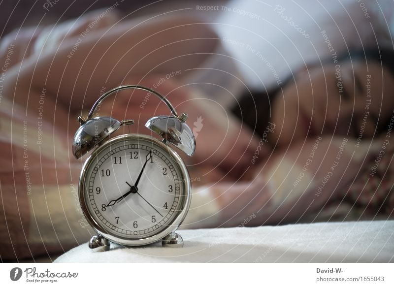 sleeping young woman with alarm clock in the foreground which indicates after 8 o'clock Woman Young woman asleep Oversleep Sleep Alarm clock late riser Time