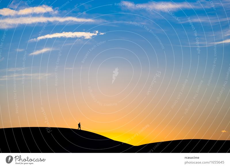 Man walking on a sand dune in the desert at sunset Desert Moody Brave Protection Beautiful Watchfulness Prompt Caution Patient Honest Disciplined Endurance