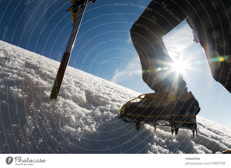 Mountain climber: detail on boot with ice crampon and ice axes Adventure Expedition Winter Snow Hiking Sports Climbing Mountaineering Success Axe Man Adults