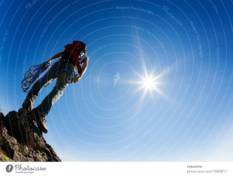 Climber stands on a rock at the end of his rout Adventure Sun Mountain Hiking Sports Climbing Mountaineering Success Rope Human being Man Adults Nature