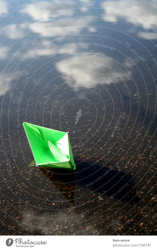 aborted Colour photo Exterior shot Day Water Blue Green Playing Clouds Float in the water Puddle Lake Watercraft Paper boat Sky Toys Reflection Wet