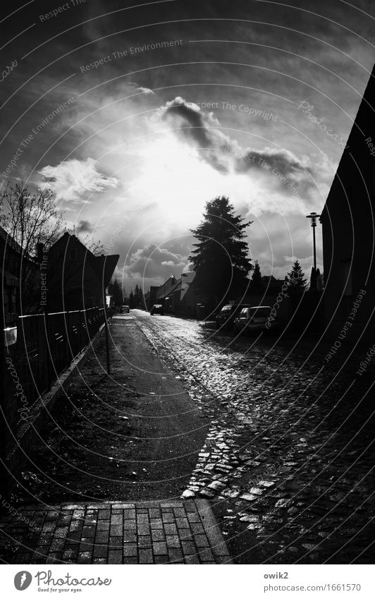 side road Sky Clouds Horizon Climate Beautiful weather Village Populated House (Residential Structure) Street Cobblestones Village road Illuminate Dark Calm