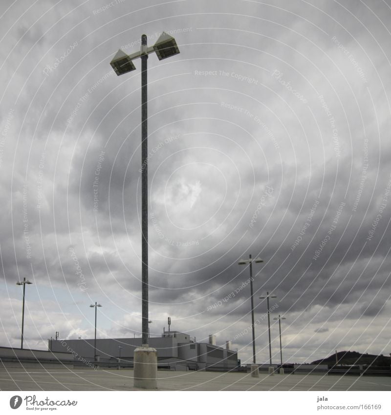 Time to go home. Subdued colour Exterior shot Deserted Day Sky Clouds Storm clouds Climate change Wind Gale Parking garage Manmade structures Building