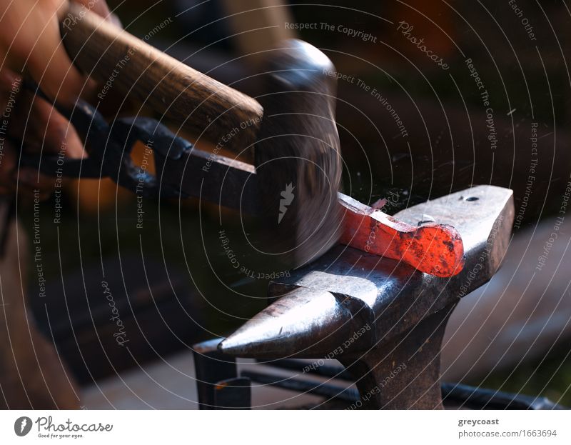 Traditional style blacksmith at work. Hammer hands and iron. Work and employment Industry Craft (trade) Tool Human being Hand 1 Art Metal Steel Old Dirty Dark