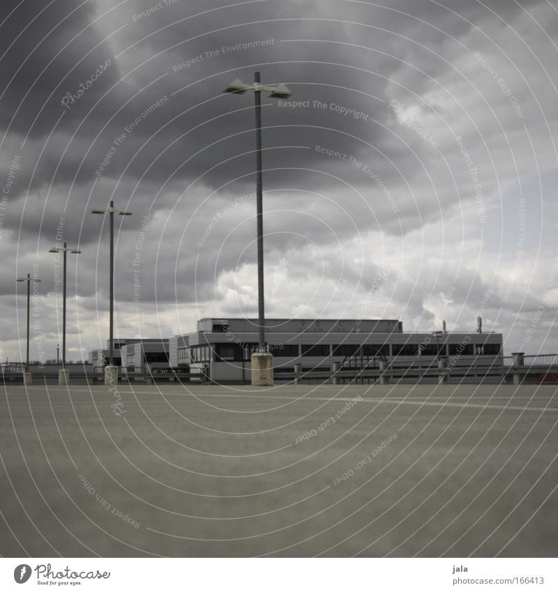 Rain's coming Subdued colour Exterior shot Deserted Day Shadow Wide angle Clouds Storm clouds Bad weather Wind Town Places Parking garage Manmade structures