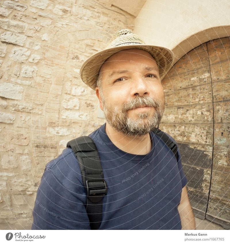 Man with beard and straw hat Wall (barrier) Wall (building) Door T-shirt Straw hat Hat Facial hair Beard Brown Beige Backpack Grinning Calm Congenial