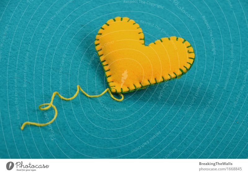 Handmade yellow stitched toy heart with thread on blue felt Leisure and hobbies Handcrafts Art Work of art Toys Heart Love Cute Soft Blue Yellow Romance