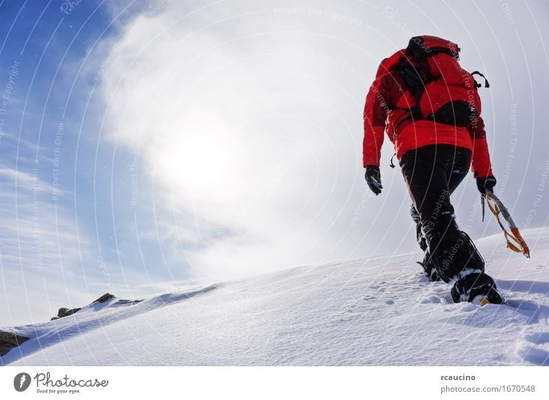 Mountaineer climbing a snowy peak in winter season. Vacation & Travel Adventure Expedition Winter Snow Hiking Sports Climbing Mountaineering Success Human being