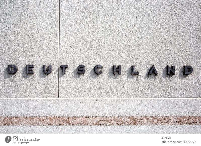 Germany. raised writing on a stone wall Characters Wall (barrier) Wall (building) Stone Metal Line Simple Positive Gray Black Self-confident Society Identity