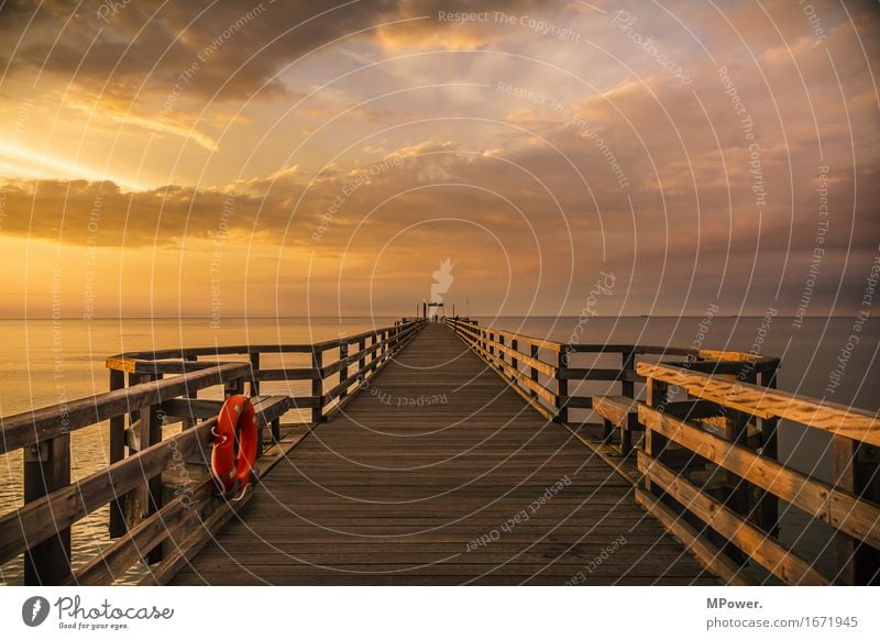 Heiligendamm Nature Water Beautiful weather Bad weather Wind Baltic Sea Footbridge Dusk Glow Ocean Coast Wood Orange Loneliness Calm Relaxation Vantage point