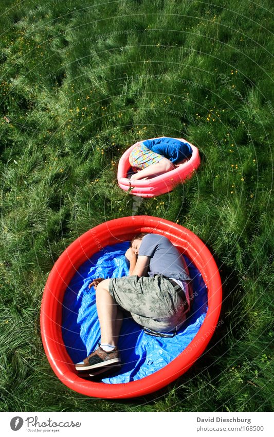 Big Babies Colour photo Exterior shot Day Contrast Sunlight Bird's-eye view Human being Brothers and sisters 2 Plant Grass Meadow Blue Green Pink Red Sleep