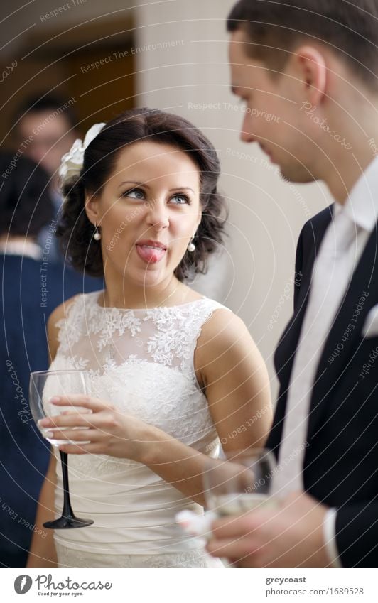 Bride and groom enjoy a quiet moment together and a drink of white wine at their wedding reception Joy Happy Beautiful Face Feasts & Celebrations Wedding