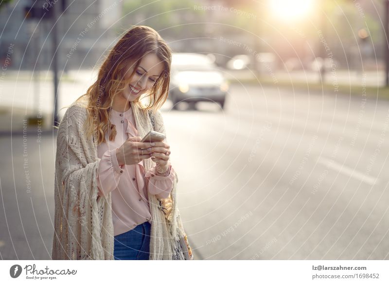 Attractive young woman checking her mobile Happy Beautiful Face Reading Summer Telephone PDA Technology Feminine Woman Adults 1 Human being 18 - 30 years