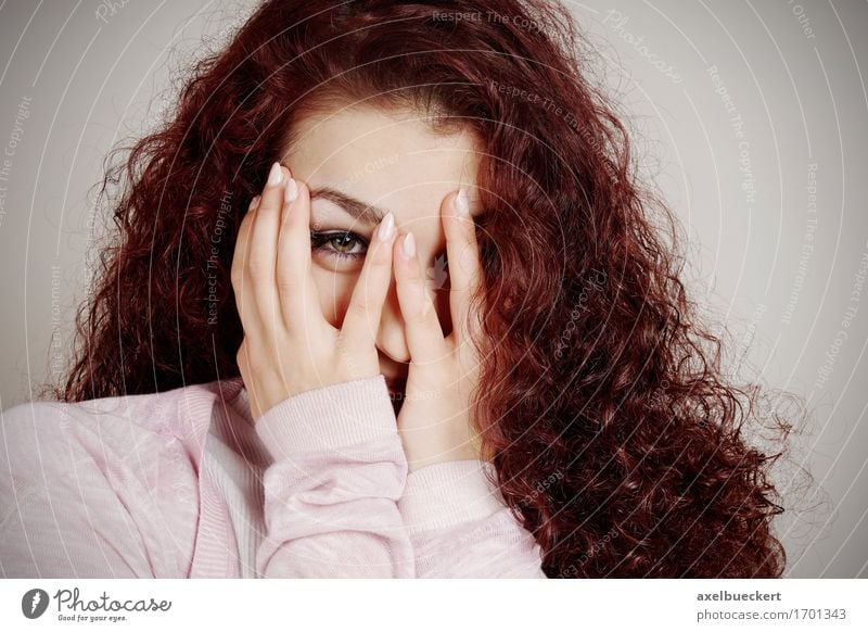 young woman peeking through fingers Joy Human being Feminine Young woman Youth (Young adults) Woman Adults 1 13 - 18 years Long-haired Curl Curiosity Emotions