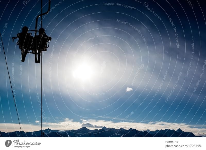 Two skiers in a chairlift backlit by the sun Vacation & Travel Tourism Winter Snow Mountain Chair Sports Skiing Human being Nature Landscape Sky Diet Lift