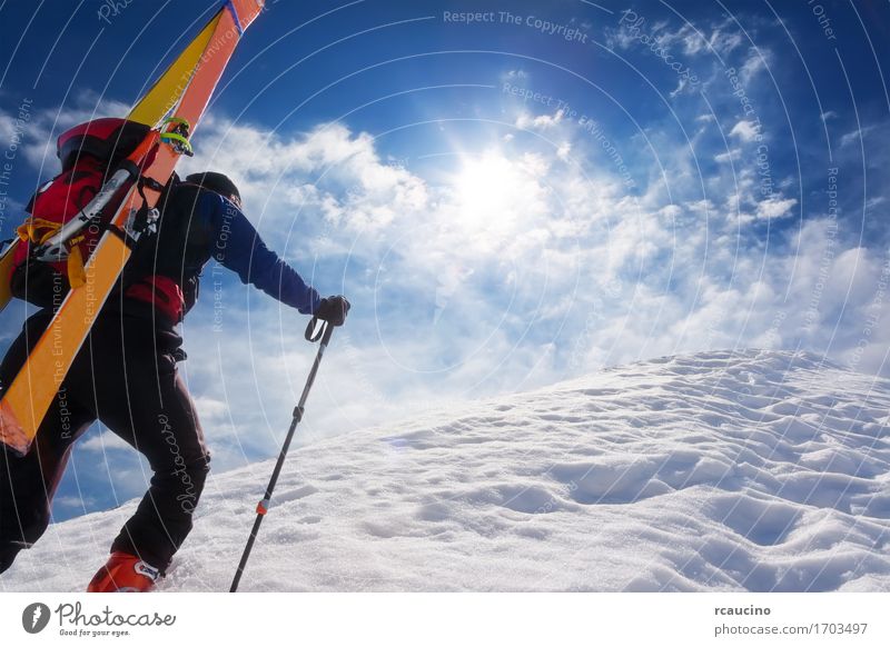 Ski mountaineer walking up along a steep snowy ridge Vacation & Travel Adventure Winter Snow Mountain Hiking Sports Climbing Mountaineering Success Human being