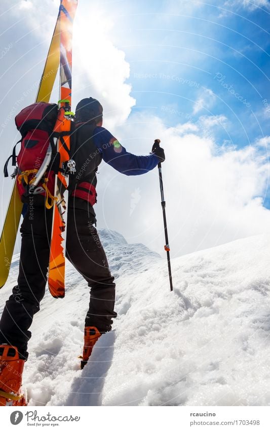 Ski mountaineer walking up along a steep snowy ridge Vacation & Travel Adventure Winter Snow Mountain Hiking Sports Climbing Mountaineering Success Human being