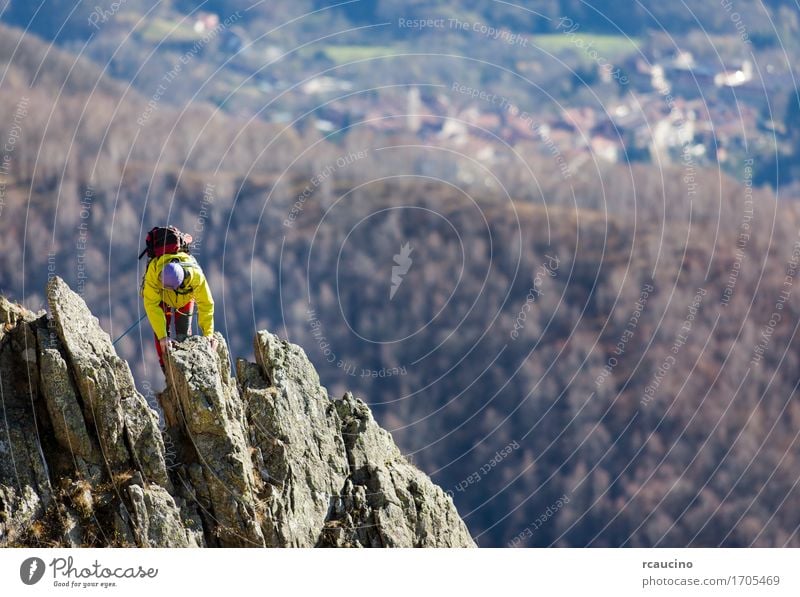 Climber struggle to the summit of a challenging ridge Adventure Mountain Hiking Sports Climbing Mountaineering Rope Human being Man Adults Nature Rock Power