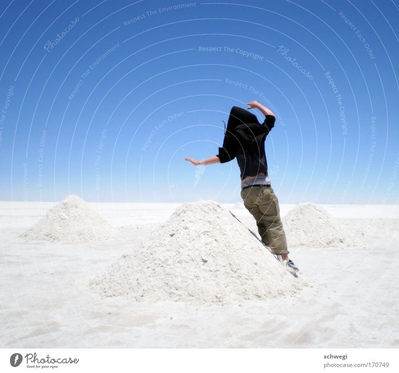 slanted salt mountains Colour photo Day Jump Hop 1 Human being Nature Landscape Sky Desert Salar de Uyuni Salt flats Exceptional Blue White Joy Cool (slang)