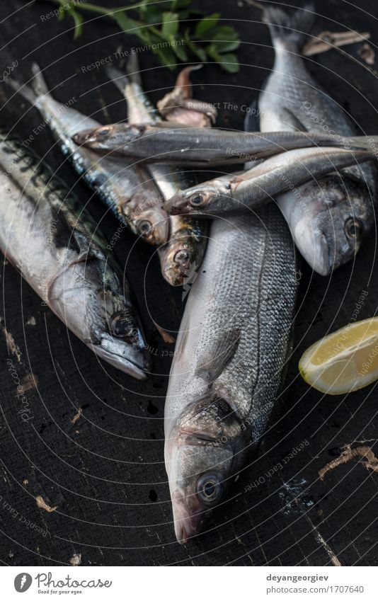 Raw fish. Sea bream, sea bass, mackerel and sardines Seafood Lunch Pan Fresh Blue Black see bass Lemon cooking background healthy Frying Fat Mackerel head