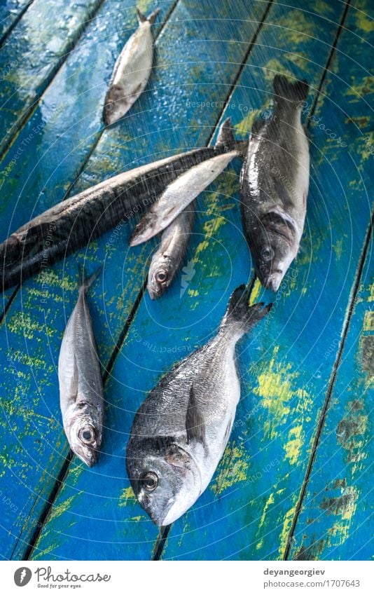 Wash fish. Sea bream, sea bass, mackerel and sardines Seafood Lunch Pan Fresh Blue Black wash watter see bass Lemon Raw cooking background healthy Frying Fat