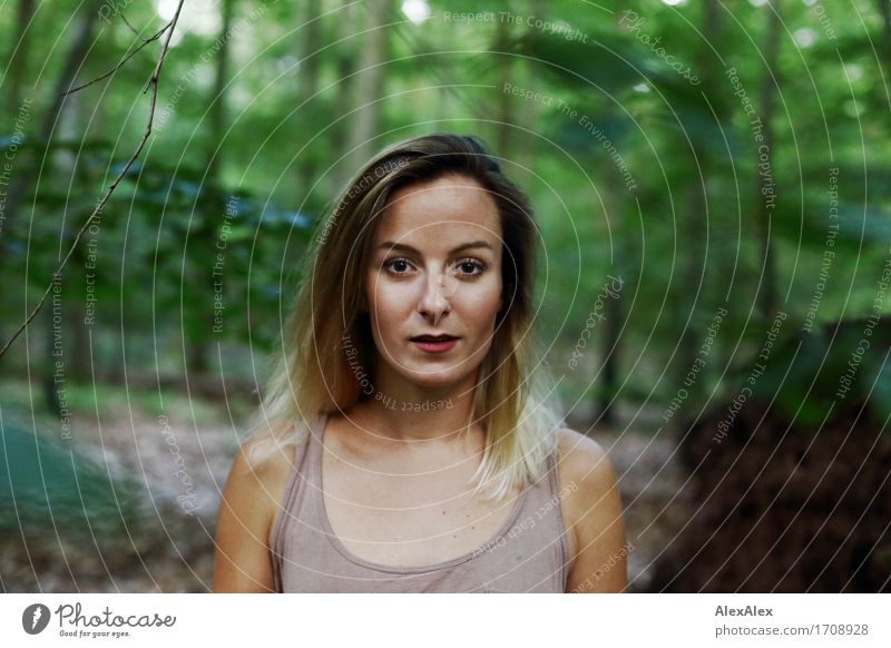 Young woman with long hair stands in the forest and looks directly into the camera Exotic Hiking Youth (Young adults) Face 18 - 30 years Adults Nature