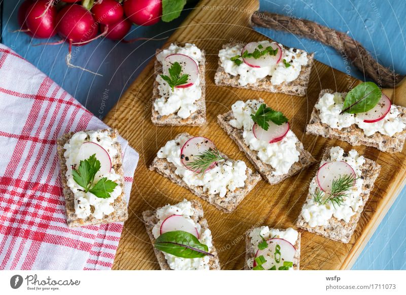 Crispbread with cottage cheese radishes and herbs Herbs and spices Wood Blue Radish Chives Dill Parsley beetroot leaves Wooden board Snack healthy snack vital