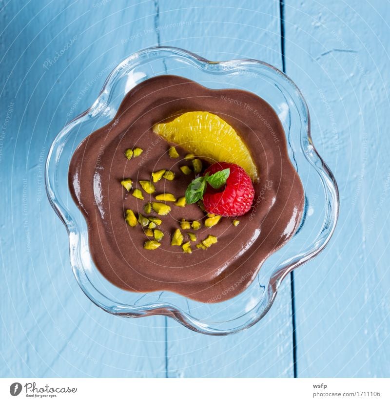 Chocolate pudding dessert with orange and pistachio Dessert Wood Blue chocolate pudding Pudding Nut spread Mousse au chocolat Cream Orange Pistachio raspberry