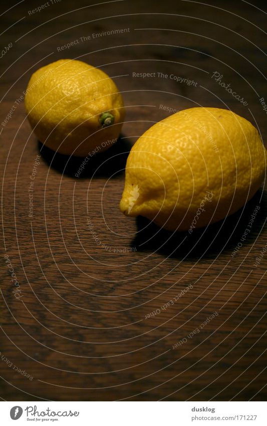 lemons Colour photo Interior shot Close-up Artificial light Central perspective Food Fruit Orange Organic produce Vegetarian diet Diet Wood Illuminate Exotic