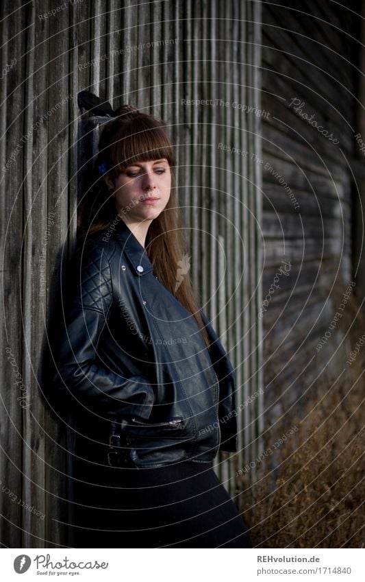 Carina - Young woman leaning against a wooden wall portrait Human being Adults 18 - 30 years Day Exterior shot Leather jacket Loneliness Emotions Moody Black