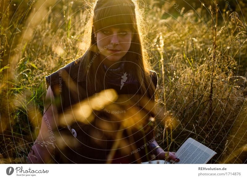 Carina reads. Human being Feminine Young woman Youth (Young adults) Woman Adults 1 18 - 30 years Environment Nature Landscape Plant Flower Grass Meadow Brunette