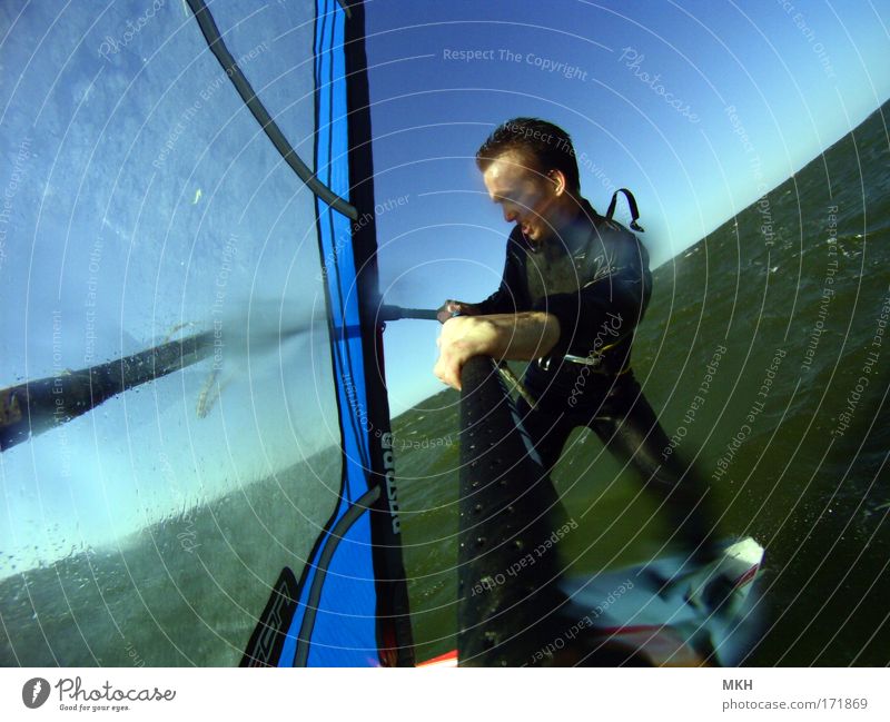 surfing the baltic sea Colour photo Exterior shot Day Shadow Sunlight Motion blur Wide angle Full-length Looking away Joy Leisure and hobbies Summer Ocean Waves